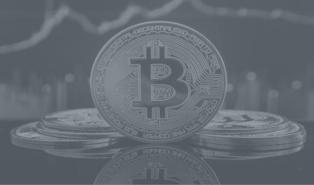 Bitcoin coin against a stock market chart backdrop